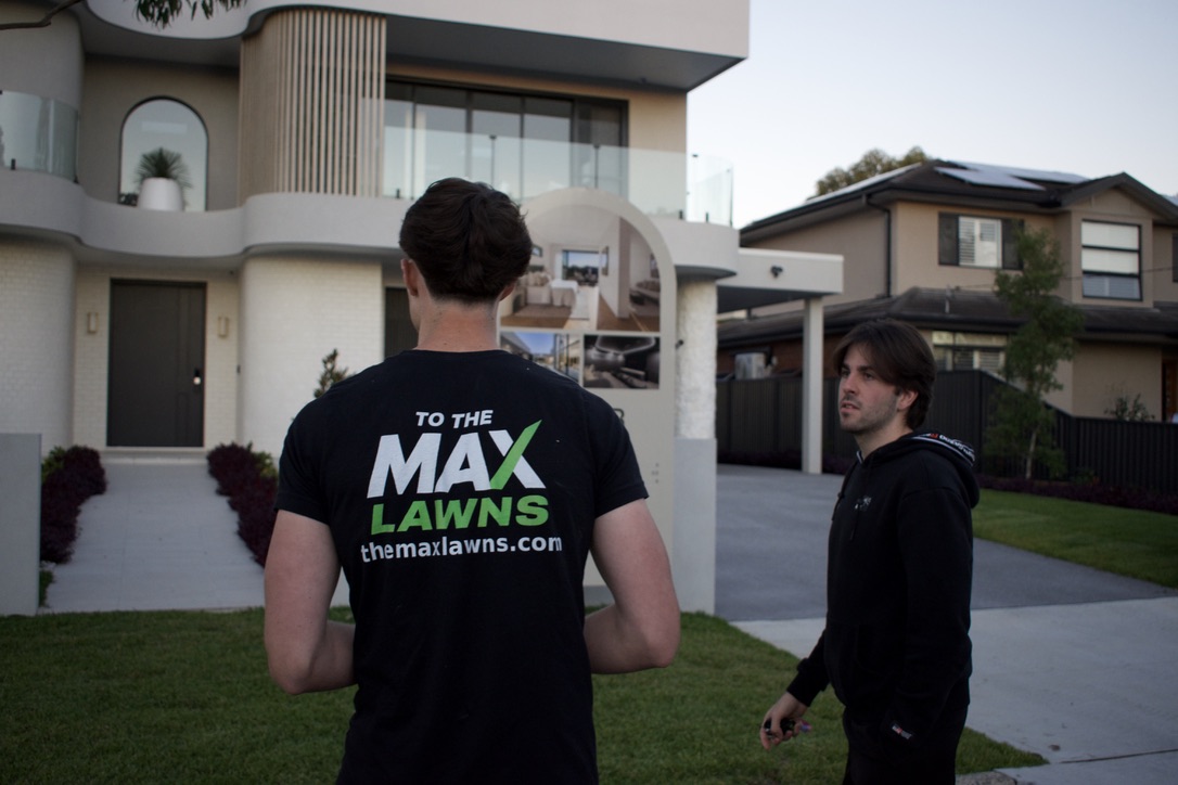 Max from To The Max Lawns speaking with a customer outside their home